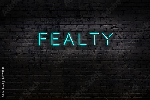 Neon sign. Word fealty against brick wall. Night view