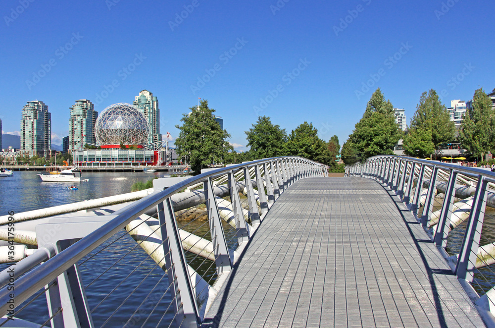 Fototapeta premium Olympic Village Canoe bridge in Vancouver, BC. Main street Science World dome in the background.