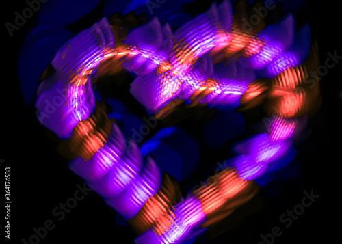 Light painting heart shape over black background