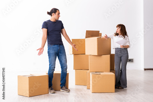 Young pair and many boxes in divorce settlement concept