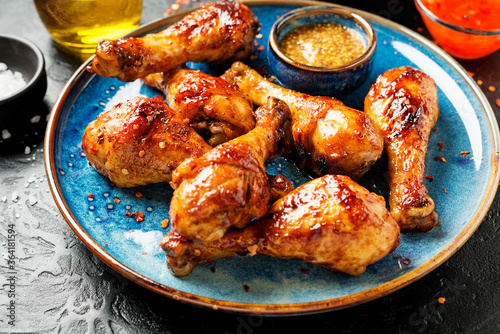 Roasted spicy chicken legs with mustard and chili sauce.