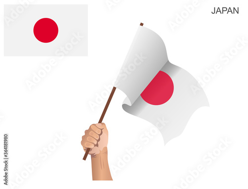 Japanese national flag raised with a stick held by hand to inflame the spirit of statehood © Khusnul