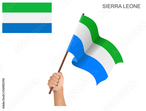 Sierra Leone state flag hoisted with a stick held by hand to inflame the spirit of statehood