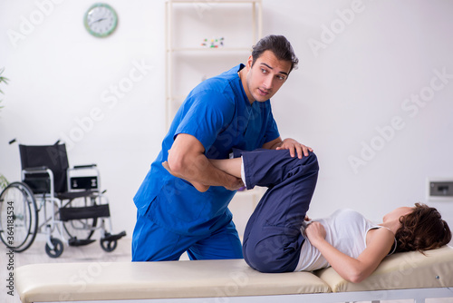 Injured woman visiting young male doctor osteopath © Elnur