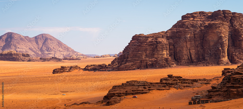 Fototapeta premium Mountains and red desert in Wadi Rum, famous desert in Jordan, Arab. Panoramic banner portion