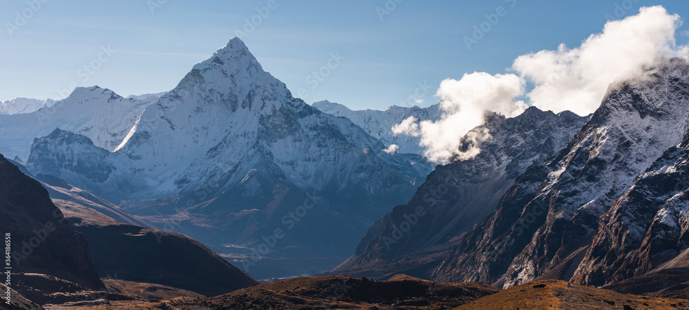 Obraz premium Ama Dablam mountain peak, most beautiful peak in Everest region view from Chola pass, Hima;ayas mountain, Nepal. Panoramic banner portion