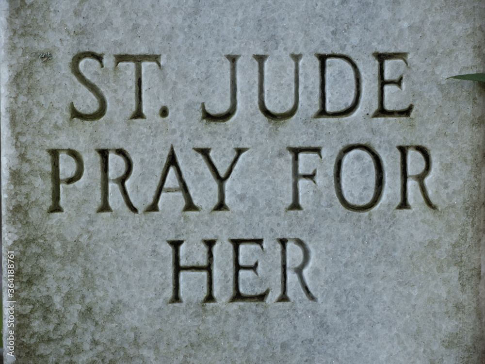 Closeup of headstone inscribed with text 