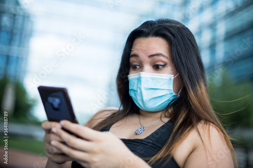 A woman wears a surgical mask to protect herself from COVID-19 photo