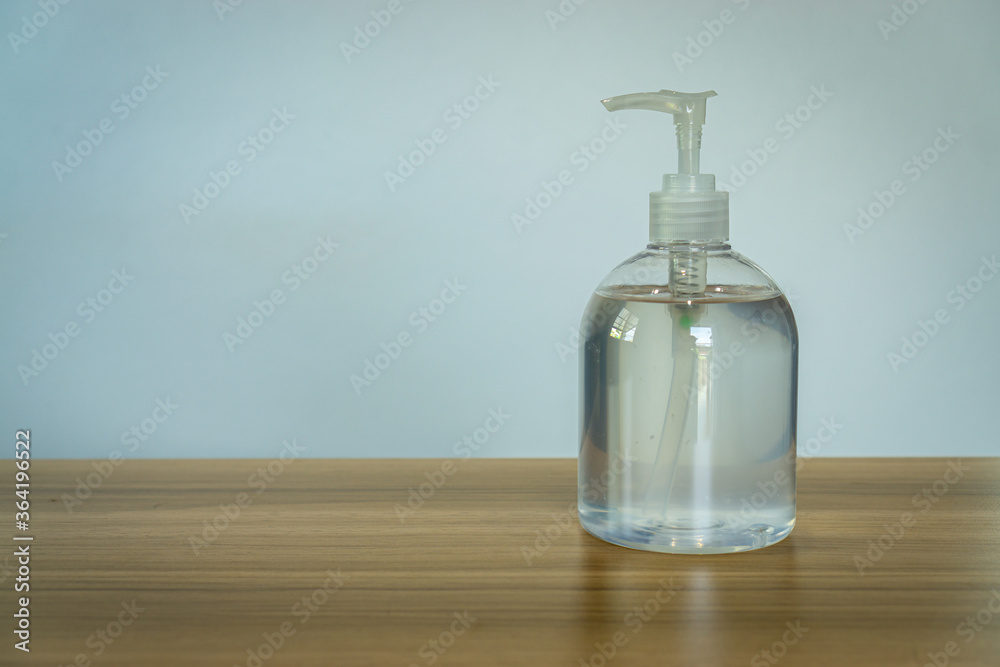 close up of Clear hand sanitizer in a clear pump bottle on wooden table background, Corona virus hands hygiene close up of Clear hand sanitizer in a clear pump bottle on wooden table background, Corona virus hands hygiene