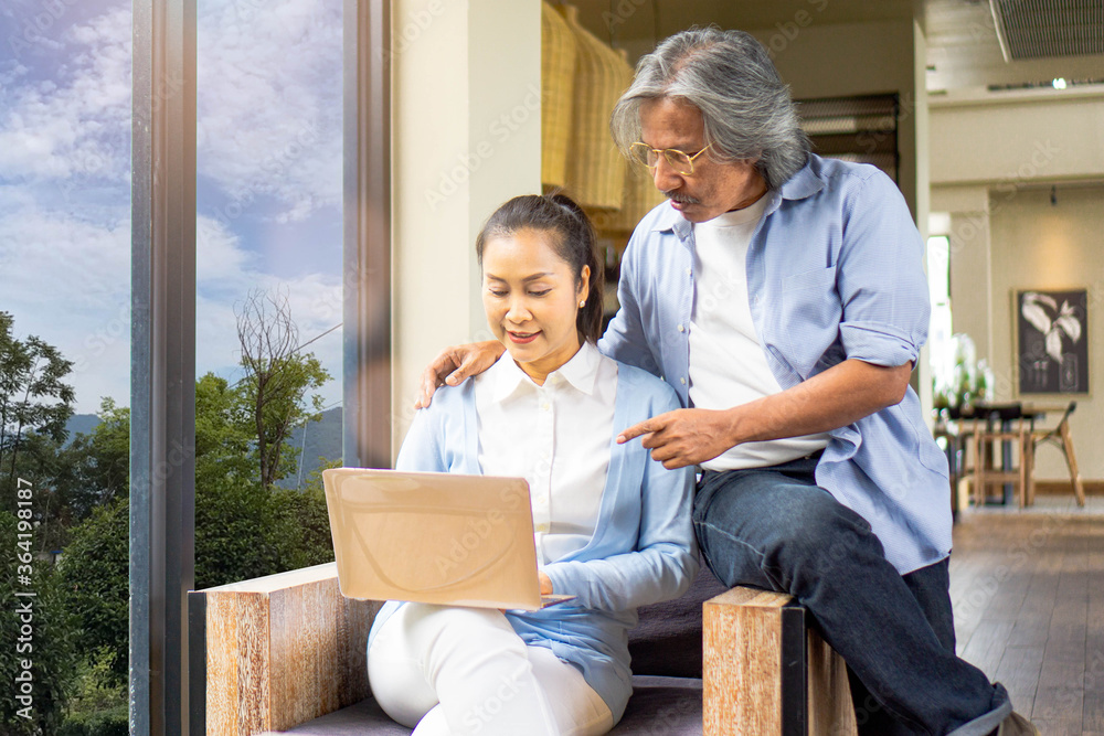 Asian of loving senior couple using laptop computer in cafe,Family concept Asian of loving senior couple using laptop computer in cafe,Family concept
