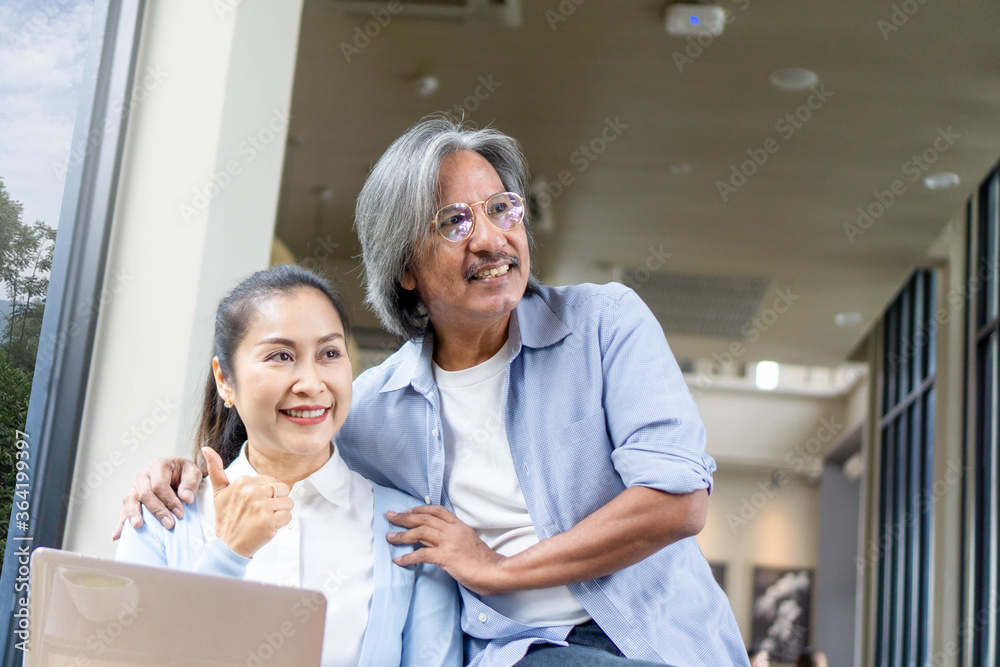 Asian of loving senior couple using laptop computer in cafe,Family concept Asian of loving senior couple using laptop computer in cafe,Family concept