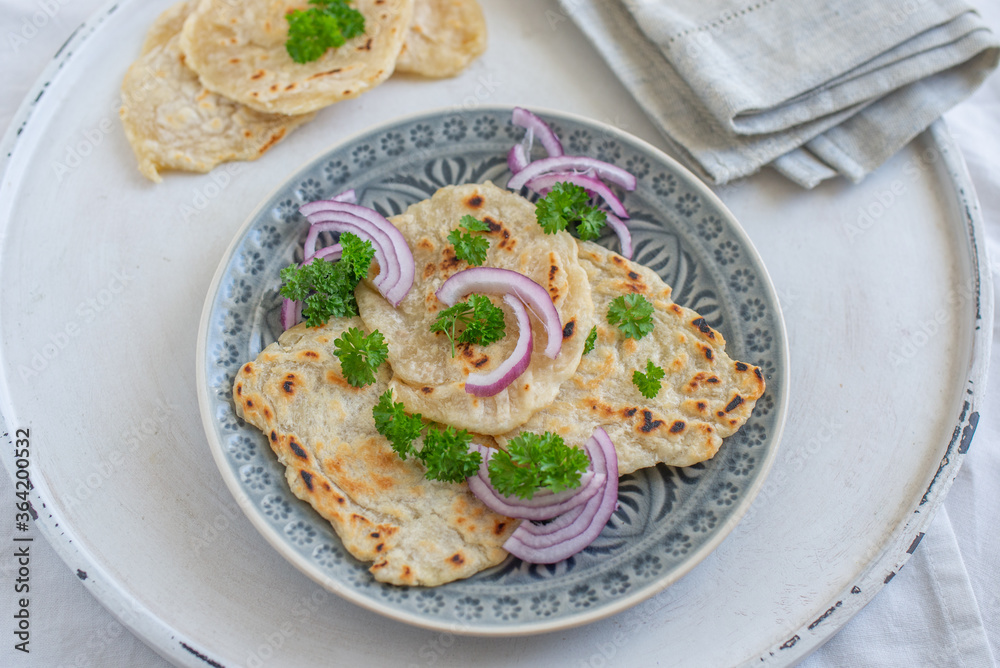Onion naan - traditional indian bread. pita bread or scones with green onions