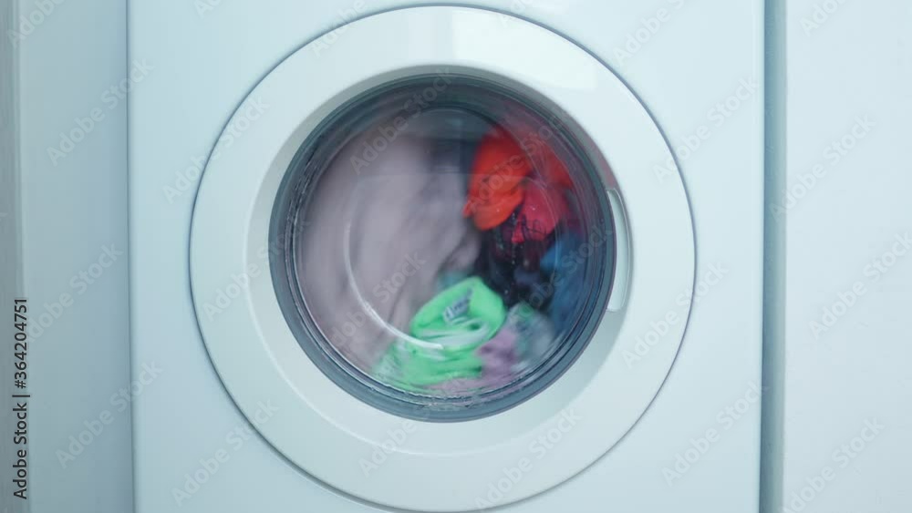 Spinning drum of a washing machine with casual clothes. Laundry day
