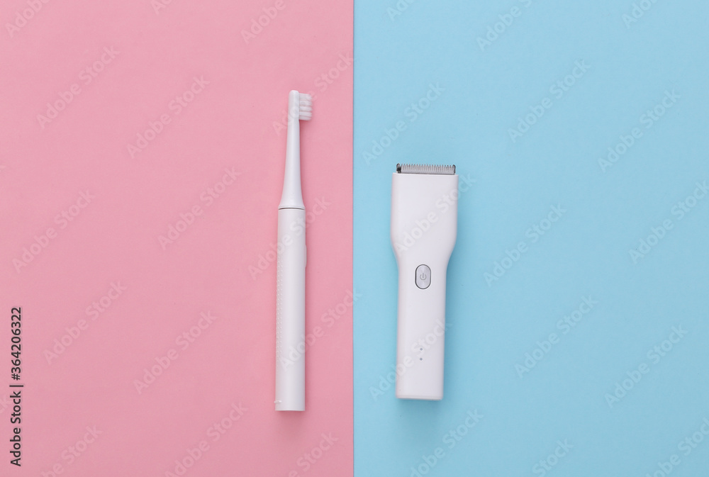 Hair clipper and toothbrush on a pink blue pastel background. Top view Hair clipper and toothbrush on a pink blue pastel background. Top view