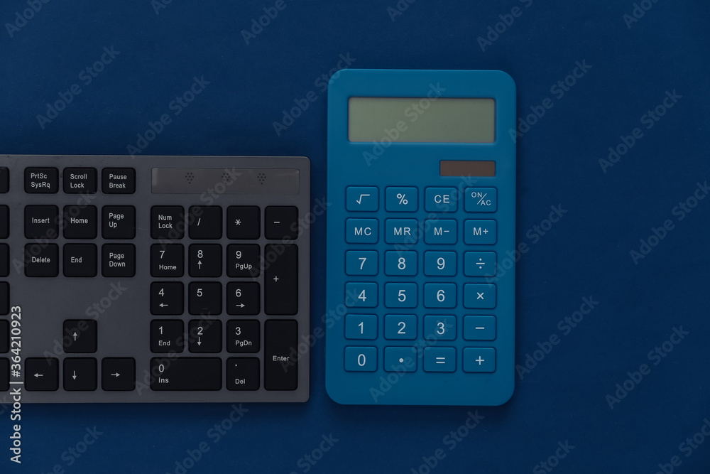 PC keyboard with calculator on a classic blue background. Top view PC keyboard with calculator on a classic blue background. Top view