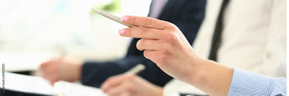 Bunch of people sitting in queue with clipboards and pens making some notes closeup Bunch of people sitting in queue with clipboards and pens making some notes closeup