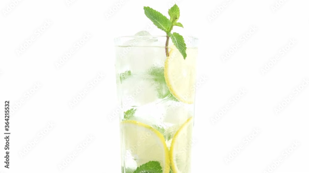 put leaf of mint in glass with sparkling water, ice, lemon and mint. Refreshing drink with sparkling water, lemon and mint, lemonade put leaf of mint in glass with sparkling water, ice, lemon and mint. Refreshing drink with sparkling water, lemon and mint, lemonade