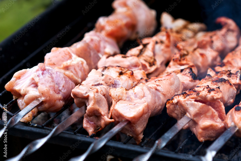 Roasted meat cooked at barbecue with smoke. Roasted meat cooked at barbecue with smoke.