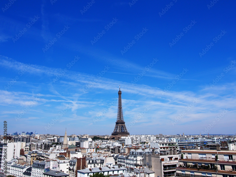 Paris skyline with the Eiffel Tower in the clear sky.