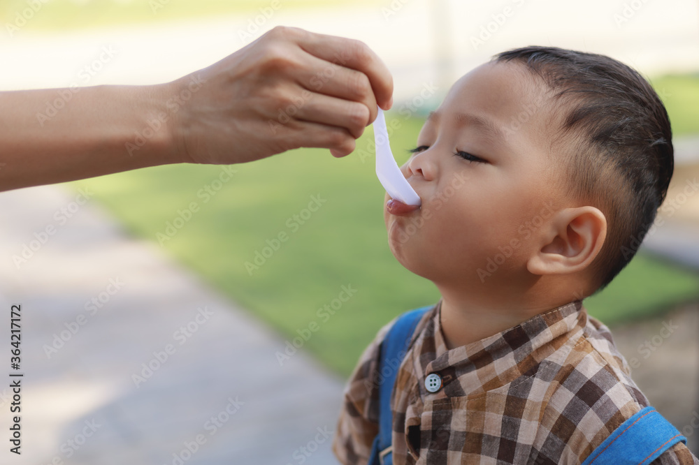 Baby boy eating food that mother provided Baby boy eating food that mother provided