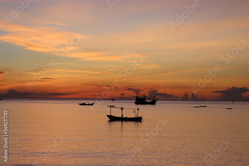 fishing boats at sunset