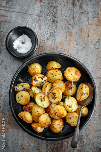 Roasted Potatoes with Mustard and Rosemary Top View on Timber