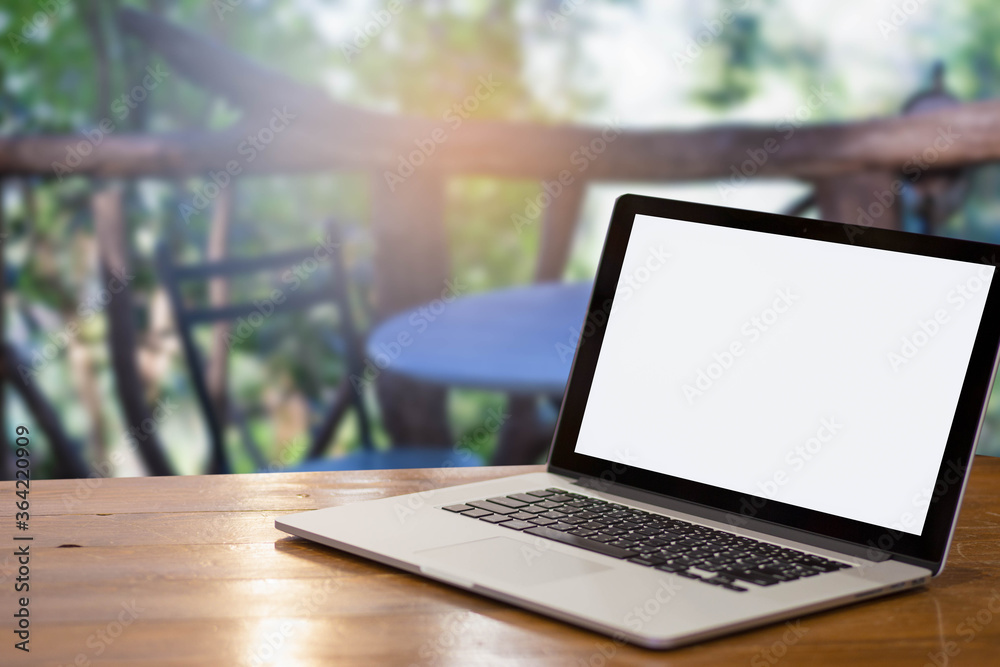 laptop on a wooden table in garden. laptop on a wooden table in garden.