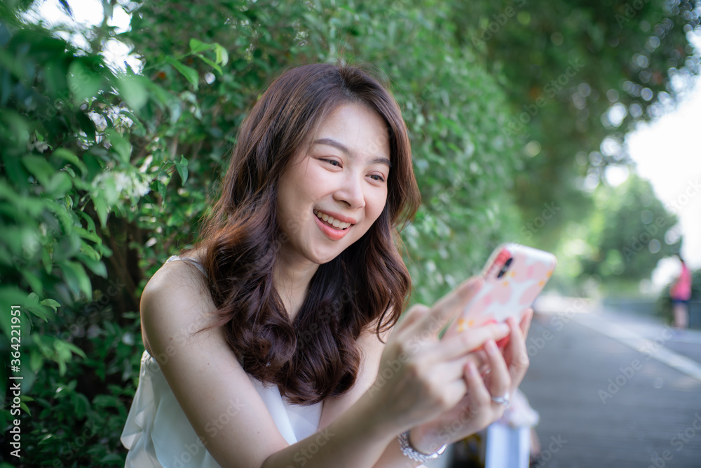 Portrait of beautiful hipster smiling young woman reading message in smartphone Portrait of beautiful hipster smiling young woman reading message in smartphone