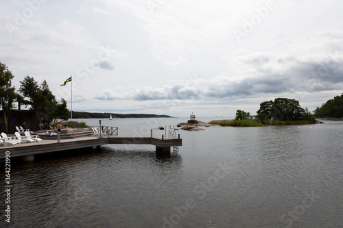 A view in the Swedish archipelago and some people is taking a relaying bath in the hut tub