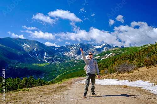 A Man Throw Snow Up in Summer Mountain View 2