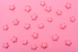 Solid pink background with paper stars in a children's style. Template for scrapbooking.