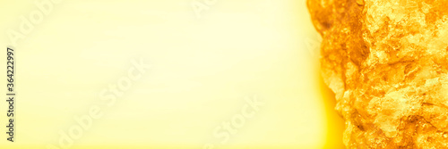 Narrow horizontal background in yellow tones bounded by yellow stone on one side and with empty space for text or heading