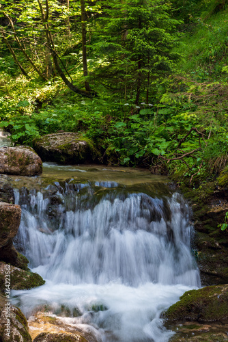 Small waterfall with stone and forest around on Nove diery gorge in Mala Fatra mountains in Slovakia