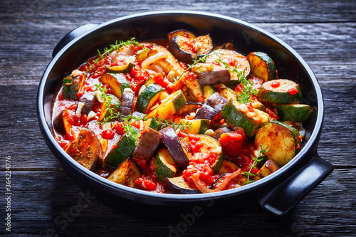 veggies ragout in a black ceramic dish photo