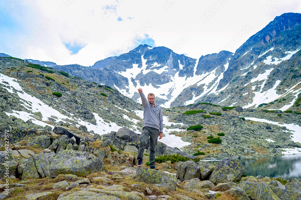 Man in Superman Pose with Mountain Landscape
