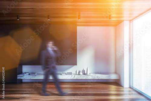 Man walking in white and black living room