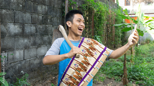 Asian man is happy while looking at his cellphone photo