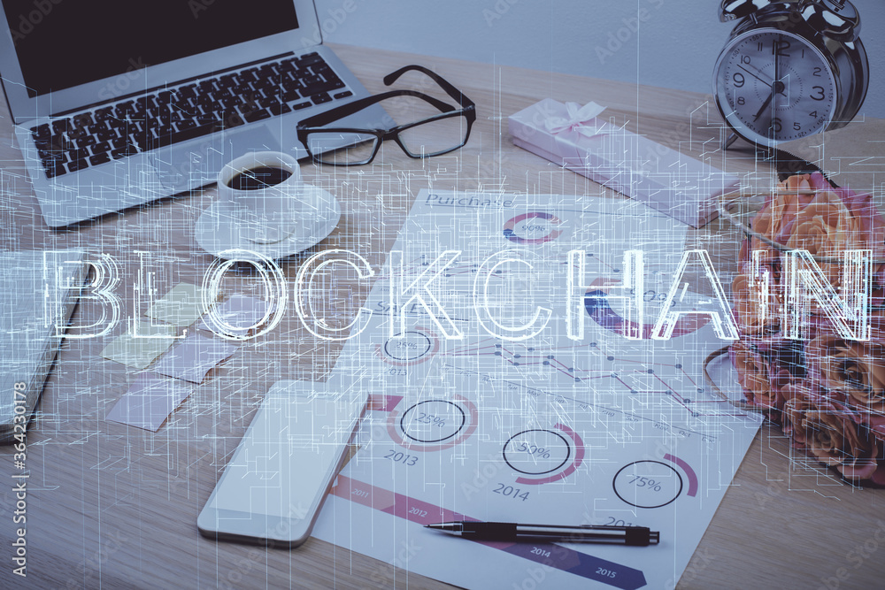 Double exposure of blockchain and crypto economy theme hologram and table with computer background. Concept of bitcoin cryptocurrency. Double exposure of blockchain and crypto economy theme hologram and table with computer background. Concept of bitcoin cryptocurrency.