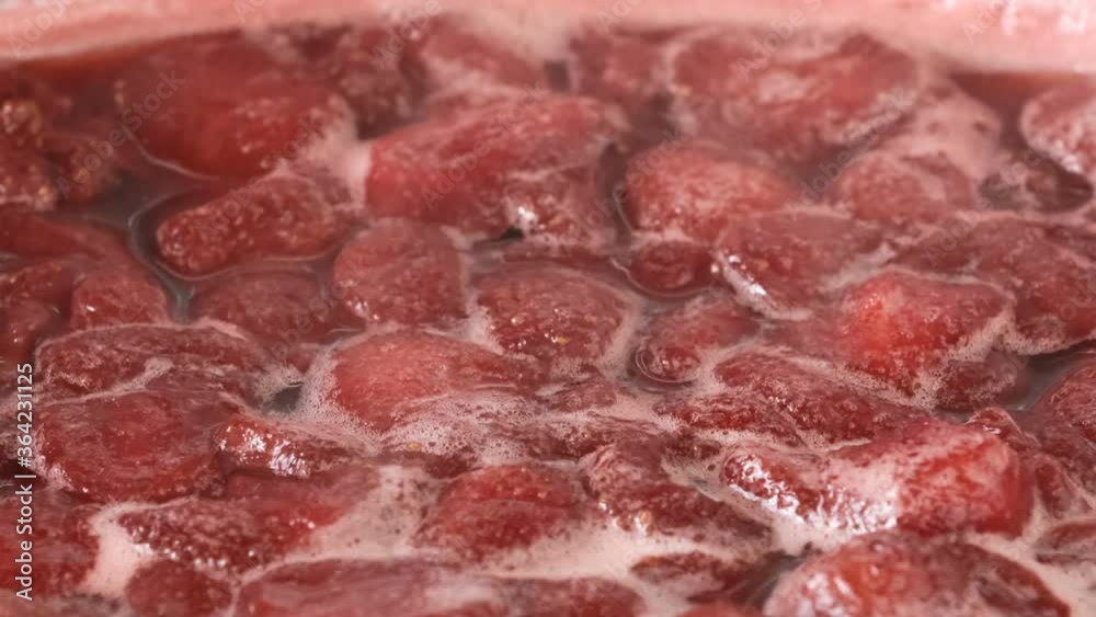 Strawberry jam in its own juice is cooked in an open bowl close-up macro video zoom and camera movement apply food background Strawberry jam in its own juice is cooked in an open bowl close-up macro video zoom and camera movement apply food background