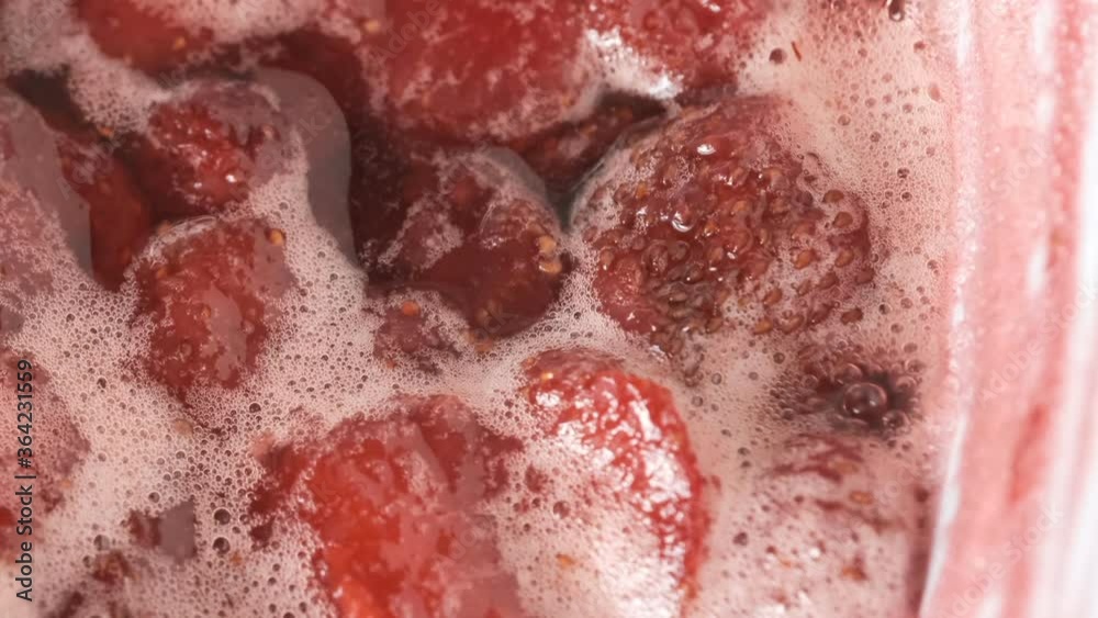 Strawberry jam in its own juice is cooked in an open bowl close-up macro video zoom and camera movement apply food background Strawberry jam in its own juice is cooked in an open bowl close-up macro video zoom and camera movement apply food background