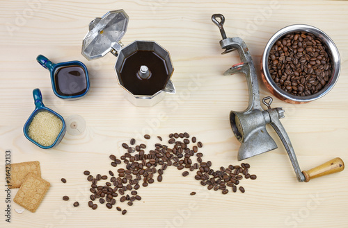 Moka pot with coffee beans and hot espresso on a wooden background. The Coffee lover concept. Czech Republic  Europe.
