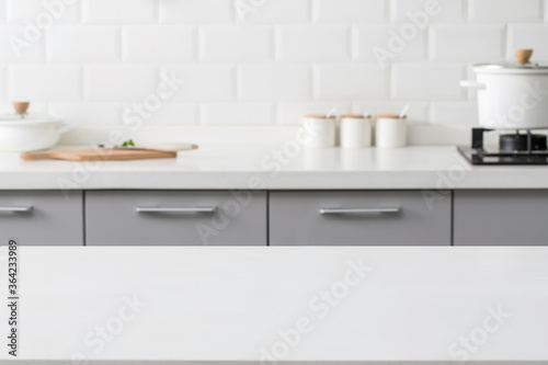empty marble stone table top and blurred view of kitchen bench background. © zhane luk