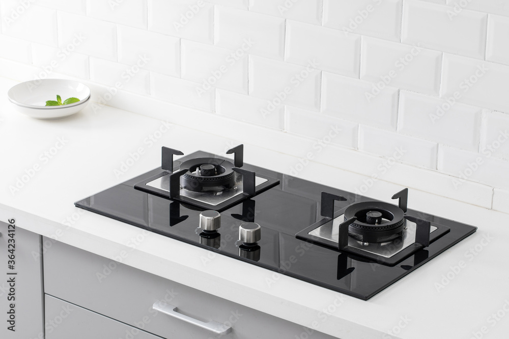 close up of gas stove in white modern kitchen. Stock Photo | Adobe Stock