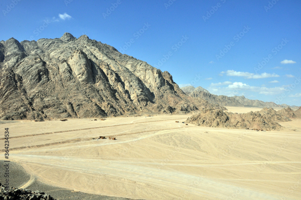 Panorama of a mountain range in the Arabian desert. An example of the sultry tonal perspective of the Egyptian open spaces. In the vicinity of Hurghada, Egypt.