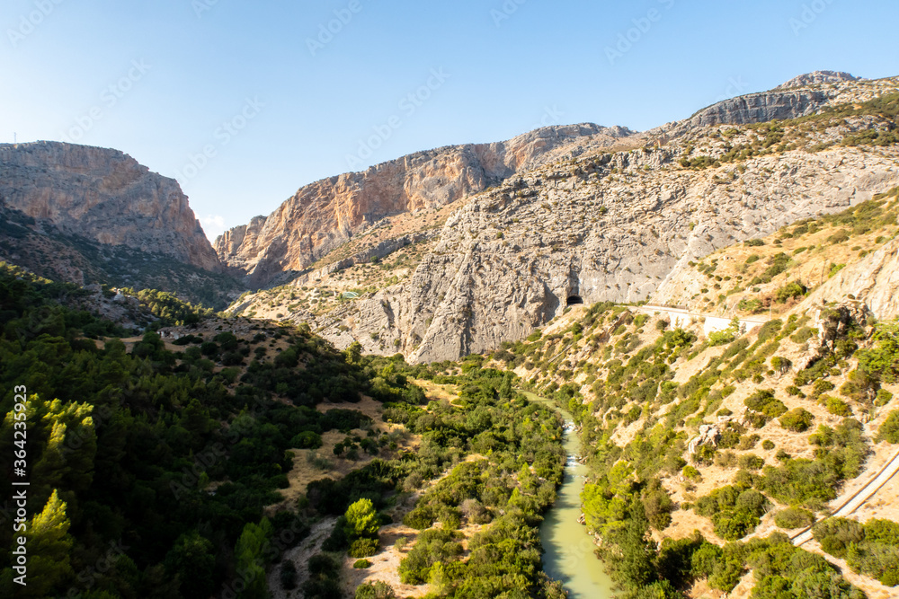 Mountain landscape view of El Chorro narrow gorge at El Caminito del Rey walkway with wild river. Spain.