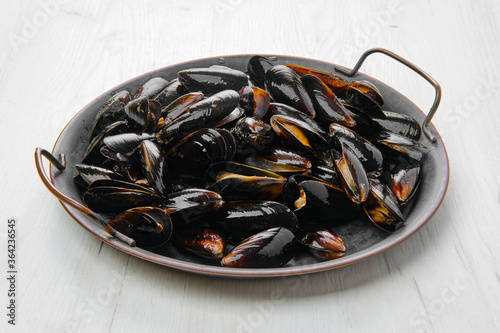 Big plate with frozen cooked mussels