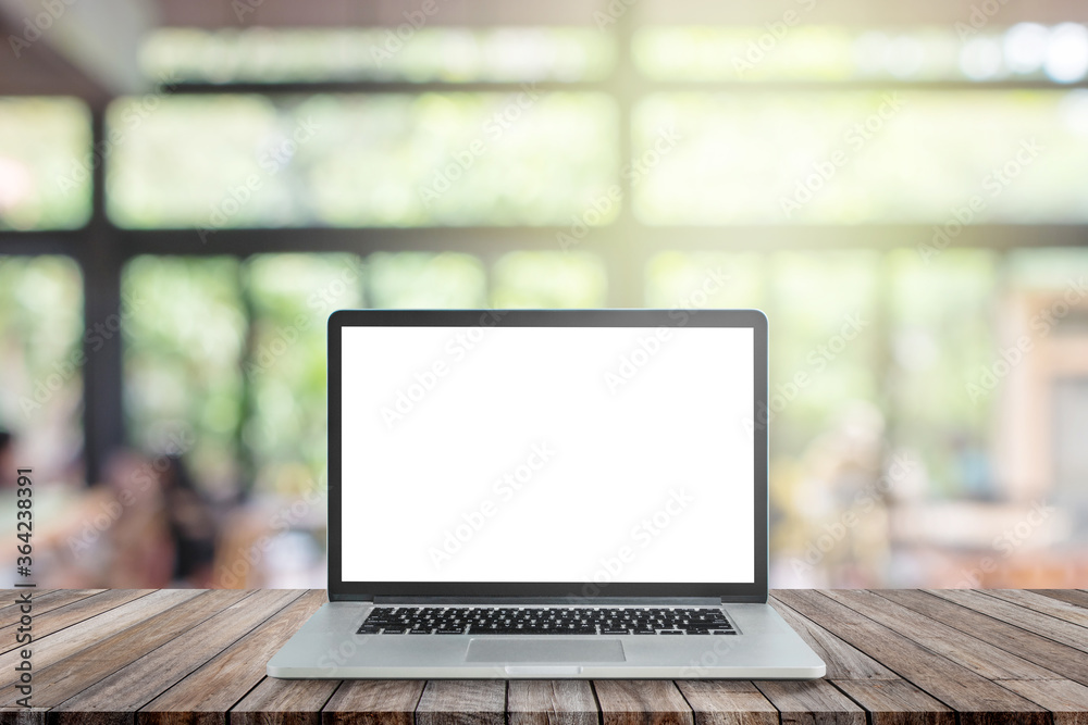 Used black laptop with blank white screen on wooden table and blurry image of coffee shop or cafe restaurant in background. Used black laptop with blank white screen on wooden table and blurry image of coffee shop or cafe restaurant in background.
