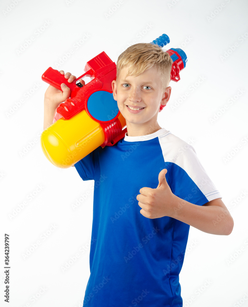 boy with water pistol on white background