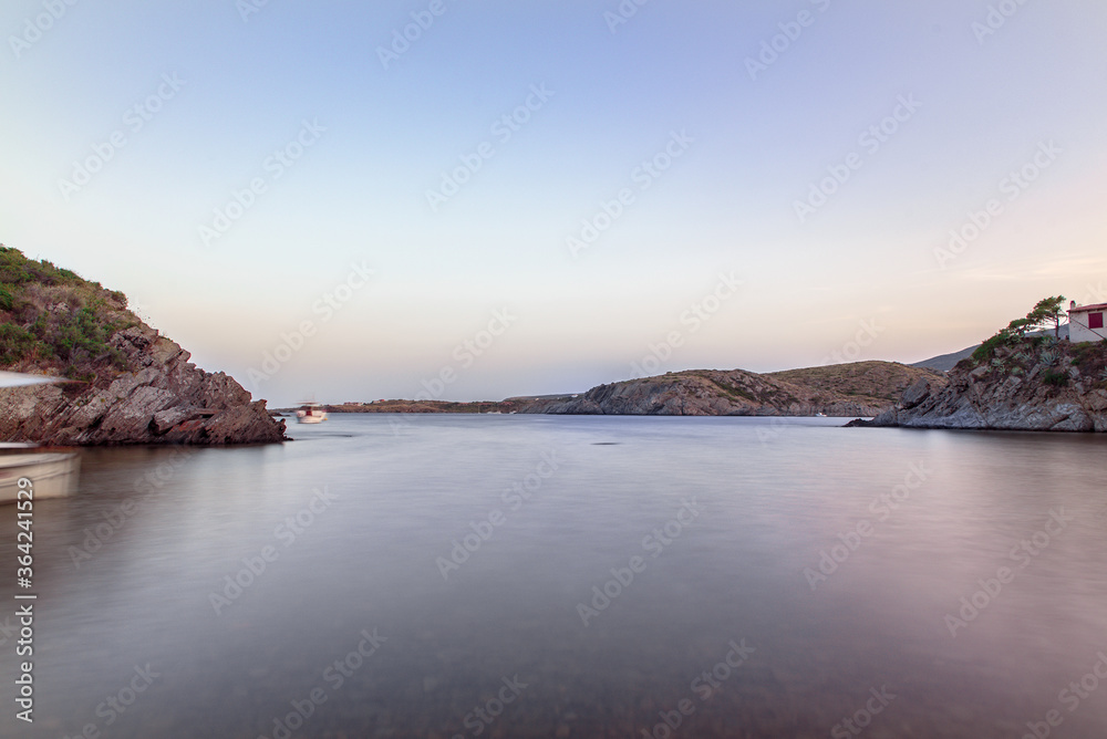 Spain Costa Brava peaceful pebble beach of the Mediterranean sea, Cala Guillola, Cadaques, Cap de Creus, Catalonia
