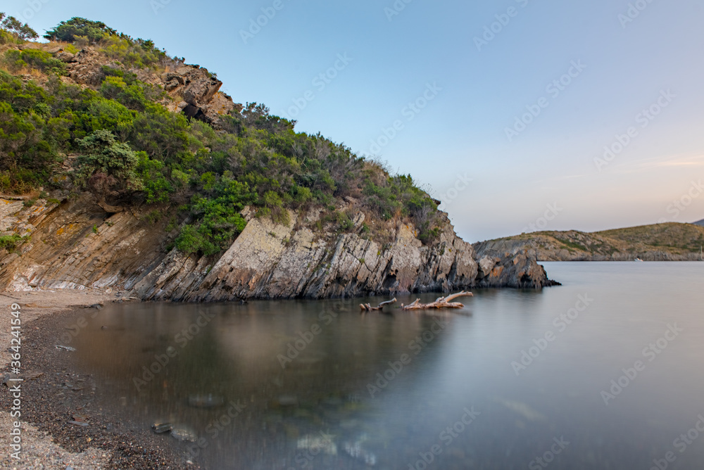 Spain Costa Brava peaceful pebble beach of the Mediterranean sea, Cala Guillola, Cadaques, Cap de Creus, Catalonia
